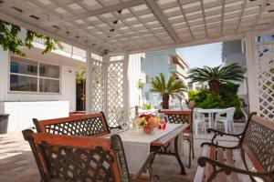 a patio with a table and chairs on a patio at Residence Hotel Claudia in Alba Adriatica