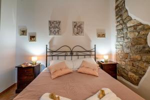 a bedroom with a large bed with two pillows at GuestHost - Lavanda Apartment with Pool & Parking in Passignano sul Trasimeno