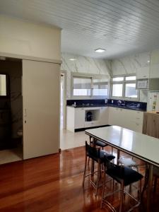 a kitchen with a table and chairs in a room at Casa da Nona in Garibaldi +14 photos