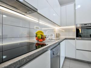 a kitchen with a bowl of fruit on a counter at Apartment Dijana by Interhome in Donji Proložac +18 photos