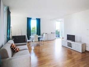 a living room with a couch and a television at Apartment Le Gemme-4 by Interhome in Meina
