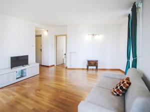 a living room with a couch and a television at Apartment Le Gemme-4 by Interhome in Meina