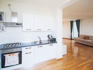 a kitchen with a sink and a stove top oven at Apartment Le Gemme-4 by Interhome in Meina +18 photos