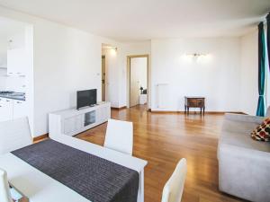a living room with a couch and a tv at Apartment Le Gemme-4 by Interhome in Meina