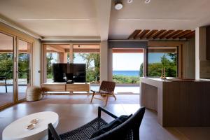 a living room with a view of the ocean at Euphoria Villa, 9 bdrs with private pools, beachfront in Kalogria