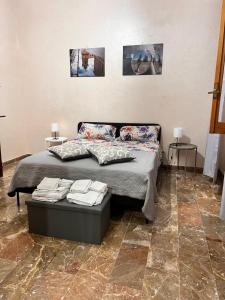 a bedroom with a bed with pillows on it at Pompeano House in Mazara del Vallo +18 photos