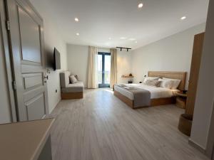 a large bedroom with a bed and a couch at Ampelitis Studios Lemnos in Agios Ioannis Kaspaka