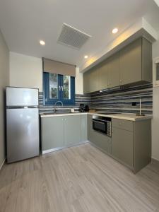 a large kitchen with a refrigerator and a sink at Ampelitis Studios Lemnos in Agios Ioannis Kaspaka +45 photos