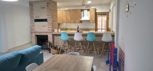 a kitchen with a table and chairs and a fireplace at Atardecer dorado in Ruidera