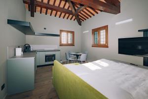 a bedroom with a bed and a kitchen with a table at Legnago Suite Apartments in Legnago +151 photos