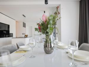 a white table with a vase with flowers in it at Villa Magic Sky 1 by Interhome in Kraj