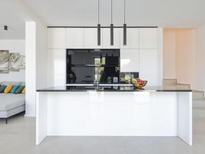 a kitchen with white cabinets and a counter top at Villa Magic Sky 1 by Interhome in Kraj +34 photos