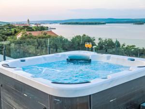 a hot tub on a balcony with a view of the water at Villa Magic Sky 1 by Interhome in Kraj