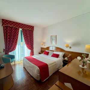 a hotel room with a bed and a table at Hotel Arcadia in Macerata