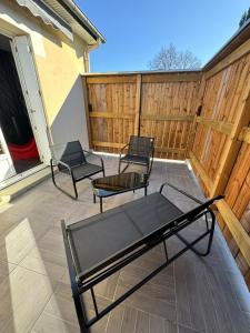 two chairs and a table on a patio at Le miroir des désirs in Argentré-du-Plessis