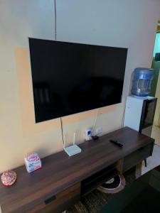 a large flat screen tv hanging on a wall at Executive 1bedroom Embu by Tsparks in Embu