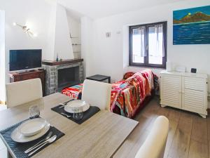a room with a dining table and a living room at Apartment Amarena by Interhome in Dormelletto