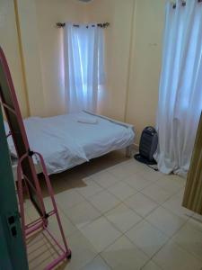 a small room with a bed and a chair at Executive 1bedroom Embu by Tsparks in Embu +7 photos