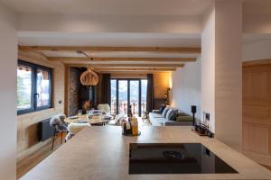 a living room with a couch and a table at Alpine Hygge by Villars Luxury in Villars-sur-Ollon