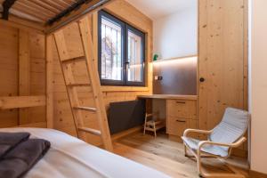 a room with a ladder and a desk and a bed at Alpine Hygge by Villars Luxury in Villars-sur-Ollon