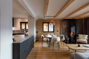 a kitchen and dining room with a table and chairs at Alpine Hygge by Villars Luxury in Villars-sur-Ollon +17 photos