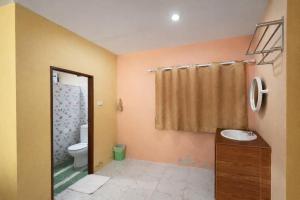 a bathroom with a toilet and a sink at FHR Krabi City Hotel in Krabi