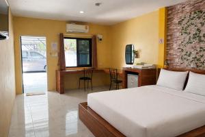 a bedroom with a bed and a desk in it at FHR Krabi City Hotel in Krabi