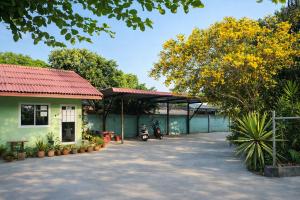 a house with a motorcycle parked in a parking lot at FHR Krabi City Hotel in Krabi +4 photos
