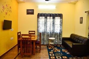 a living room with a couch and a table at Srinivasam service apartment in Madurai