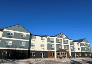 a large apartment building in a parking lot at Best Western Plus Paper Valley Hotel in Appleton
