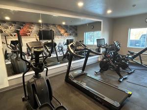 a gym with two treadmills and two exercise bikes at Best Western Plus Paper Valley Hotel in Appleton