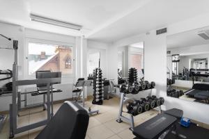 a gym with a lot of equipment in a room at Best Western Hotel Bollnas in Bollnäs