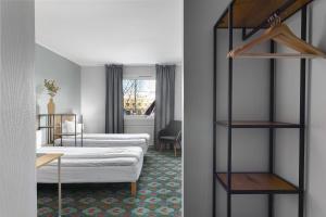 a hotel room with two beds and a book shelf at Best Western Hotel Bollnas in Bollnäs +38 photos