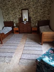 a living room with two beds and a mirror at Störsby Bed & Breakfast in Lappers +4 photos
