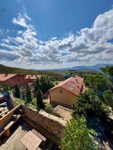 an overhead view of a house with a stone wall at Atempo Berzosa Arce in Berzosa del Lozoya