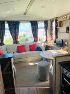 a living room with a couch and a table at Sea Salt in Padstow