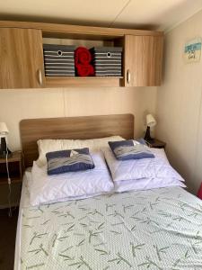 a bedroom with a bed with two pillows on it at Sea Salt in Padstow