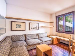 a living room with a couch and a table at Apartment Fondue by Interhome in Madesimo