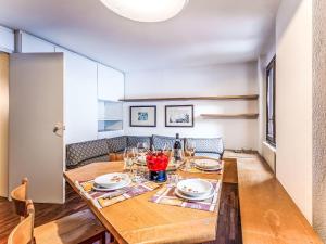 a dining room with a wooden table with wine glasses at Apartment Fondue by Interhome in Madesimo