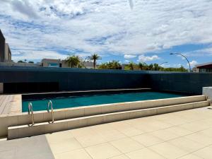 a swimming pool on the side of a building at Keddy J Apartments in Windhoek