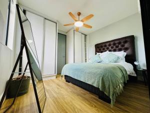 a bedroom with a bed and a ceiling fan at Keddy J Apartments in Windhoek +9 photos