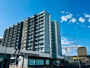 a tall building with a sign in front of it at Keddy J Apartments in Windhoek