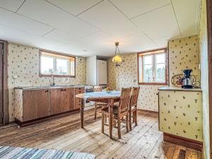 a kitchen with a table and chairs in a room at Apartment Långerud by Interhome in Mellerud