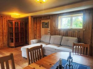 a living room with a couch and a table at Apartment Långerud by Interhome in Mellerud