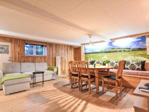 a living room with a couch and a table at Apartment Långerud by Interhome in Mellerud +15 photos