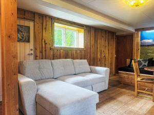 a living room with a couch and a table at Apartment Långerud by Interhome in Mellerud