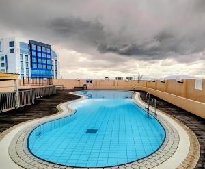 a swimming pool on the roof of a building at RIVERBANK SUITE with riverfront mountain DUN view in Kuching