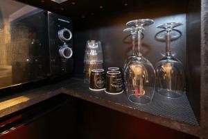 a counter with three glass bottles on a shelf at Ruby Room in Mâcon