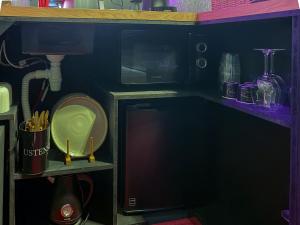 a small kitchen with a sink and a counter top at Ruby Room in Mâcon