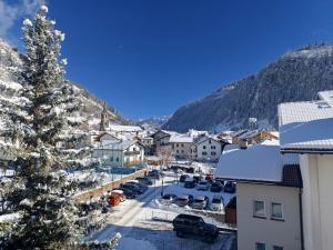 a snowy town with a christmas tree in a parking lot at Apartment Casa Dalpi by Interhome in Predazzo